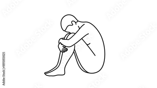 Man sitting on floor with head in knee