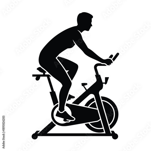 Silhouette of a person exercising on a stationary exercise bike