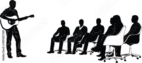 Black silhouette of a musician playing acoustic guitar for a small group of people sitting in chairs during an intimate indoor concert performance.