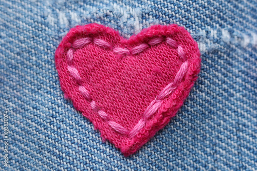 Heart-shaped patch on jeans fabric, closeup view