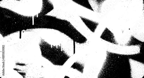 Abstract black and white spray paint texture with drips and splatters.