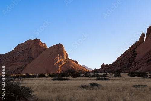 Tableau sur toile Towering red rock butte rising from desert floor in Namibia