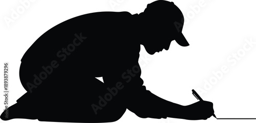 Silhouette of a man kneeling and drawing on the ground with a pencil