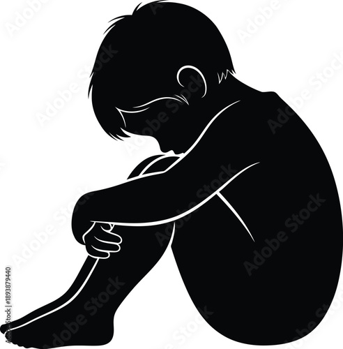 Sad child sitting alone with head down