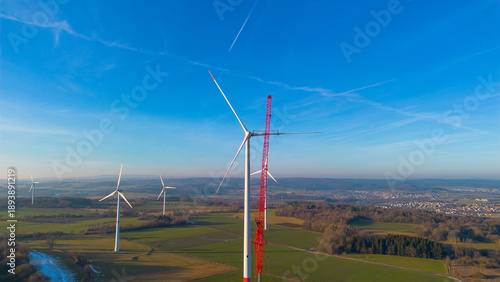 Aerial view of wind turbines and crane during onshore wind farm construction in Germany