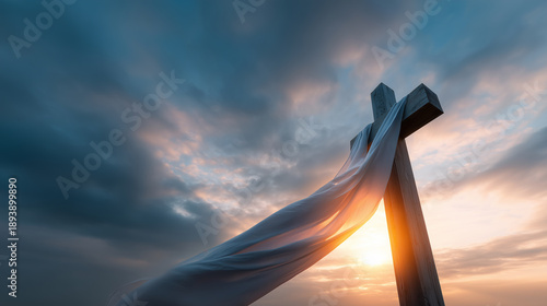Wooden cross draped with white cloth against dramatic sunrise sky symbol of hope and renewal during holy week christian faith background.
