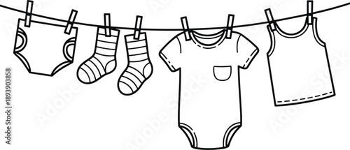 Baby clothes and socks hanging on a clothesline with clothespins Keywords: baby clothes, socks, onesie, bodysuit, t-shirt