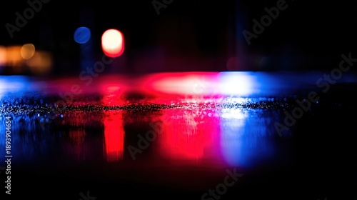 pavement. Glowing red and blue lights reflecting on wet pavement at night with dramatic contrast. mobility guides, transit brochures, designed for mobility and urban transit guides.