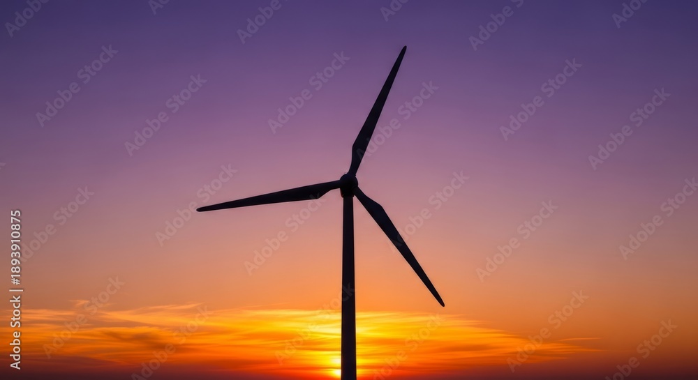 Fototapeta premium Wind turbine silhouette at vibrant sunset, purple and orange sky