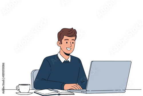 Young businessman in a suit smiling while working on a laptop at an office desk