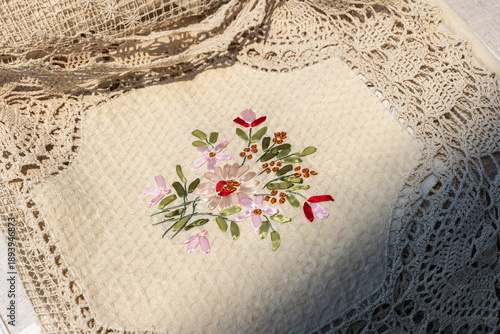 Wallpaper Mural A close-up of linen fabrics featuring colorful floral embroidery with braid Torontodigital.ca