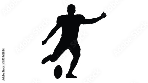 Silhouette of a man kicking an oval shaped ball possibly playing rugby or football