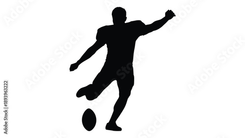 Silhouette of a person kicking a ball likely playing sports