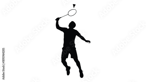 Silhouette of a badminton player preparing to smash during a game