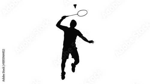 Silhouette of a badminton player in mid swing preparing to hit a shuttlecock