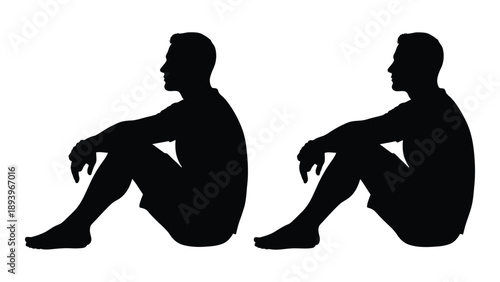 Two silhouetted figures are seated on the ground in a contemplative pose