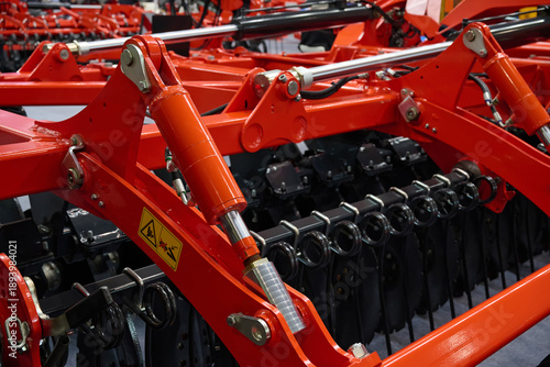 Fotografija Close-up of a large modern plow red color or disc harrow for cultivating the land