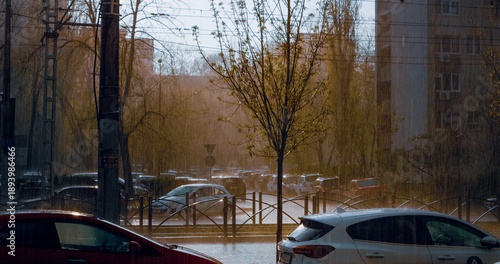 Bild auf Leinwand Intense hailstorm pelting parked vehicles near urban trees and buildings, showca