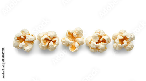 A digital photograph features five popped popcorn kernels on a white background, each with unique shapes and fluffy textures, showcasing yellow-orange centers.