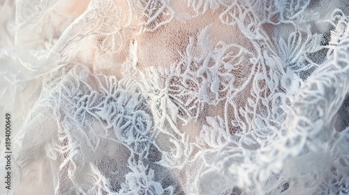 Delicate white lace fabric with intricate floral pattern