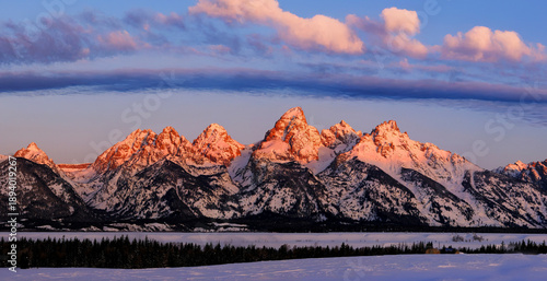 Sunrise on Teton Mountain Range in Wyoming Alpen Glow Orange With Clouds