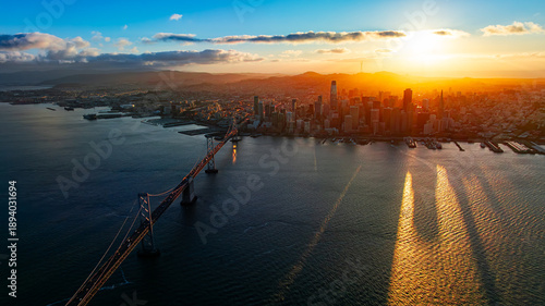 Sunset panorama of San Francisco Bay. Wide drone panorama of San Francisco Bay at sunset with skyline and bridge silhouettes.
