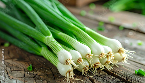 Fresh green onions on rustic wooden surface, organic and healthy vegetable, natural garden food