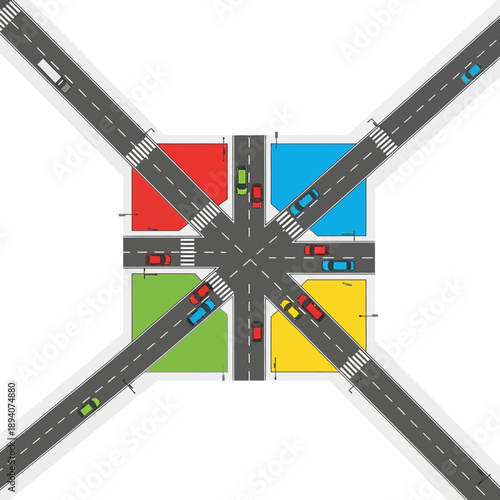 Aerial view of a busy four-way intersection with colorful quadrants and traffic.