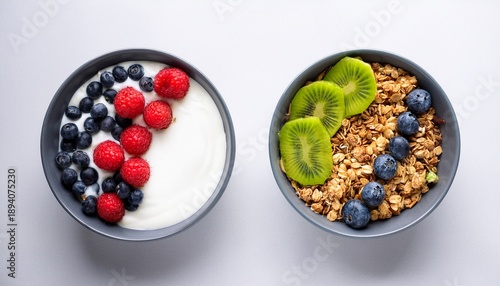 weight loss healthy lifestyle and eating two healthy breakfast bowl with ingredients granola fruits greek yogurt and berries on white background top view