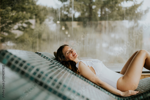 Woman relaxes on warm stone...