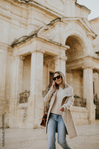 Woman walks and talks on th...