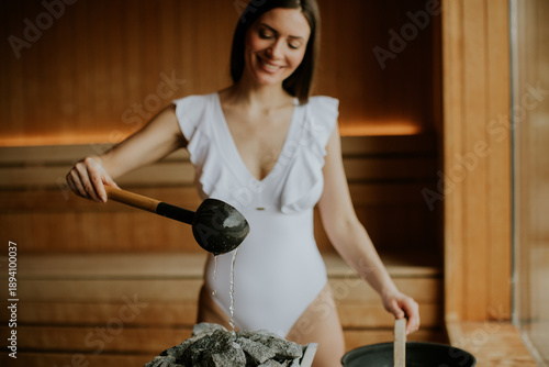 Woman pours water on stones...