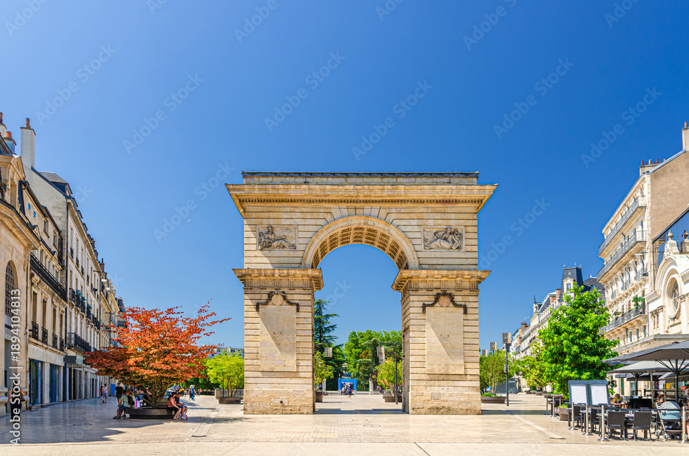 Fototapeta premium Porte Guillaume Gate Dijon's triumphal arch on Place Darcy Square with green trees in pots in old town Dijon city historical centre in sunny summer day, Bourgogne-Franche-Comte region, France