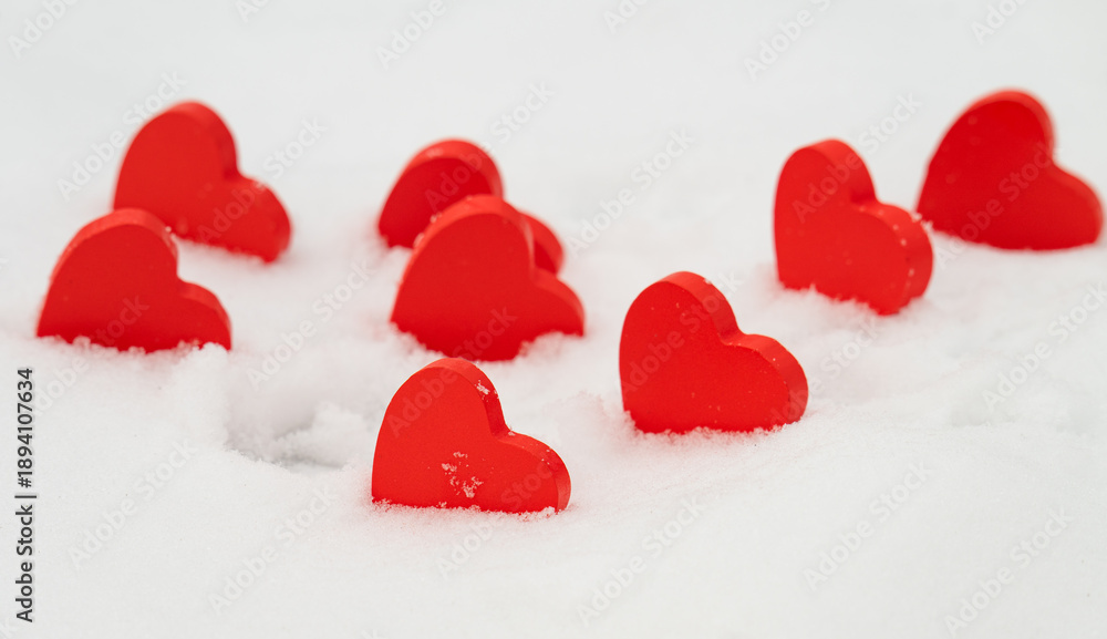 Fototapeta premium red hearts on the snow=