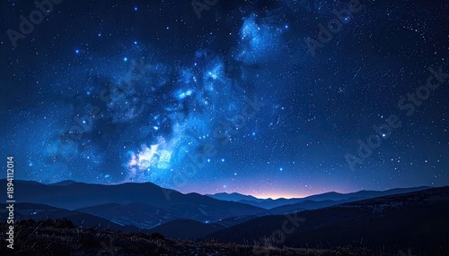 Wallpaper Mural Brilliant blue Milky Way galaxy stretching over dark, layered mountain silhouettes under a clear night sky. Torontodigital.ca