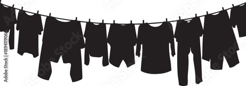 Silhouettes of clothes hanging on a line to dry