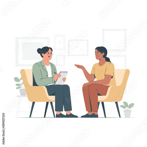 Two women talking in a therapy session with one taking notes