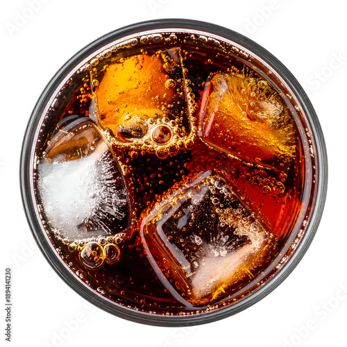 Overhead view of a brown carbonated drink in a glass with ice cubes, against a black backdrop