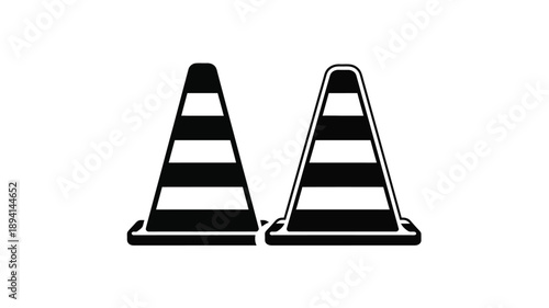 Two traffic cones stand side by side in a stark composition silhouette