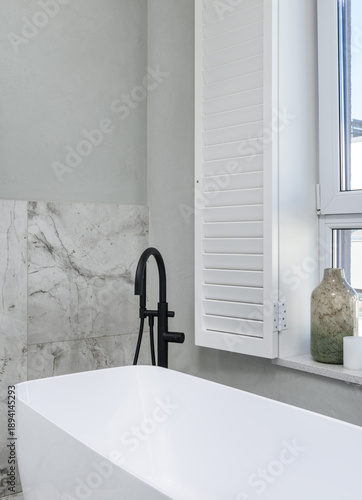 Elegant Bathtub With Marble Backdrop, Stylish Bathing Area Showcasing Modern Fixtures And Artistic Details