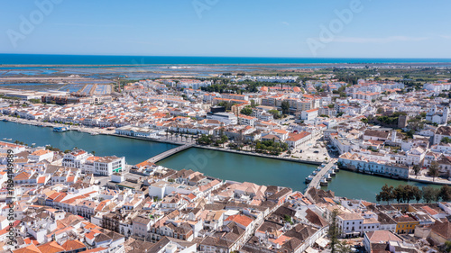 Wallpaper Mural Tavira is shown from above with rivers, white buildings, and the Algarve coast visible. The sunny weather highlights the layout of the town and landscape. River Gilao Roman bridge Torontodigital.ca