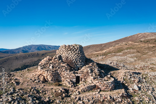 Obraz na płótnie Ancient Nuraghe Ruinas, a prehistoric stone tower standing on a rocky hill in the Sardinian countryside, Italy