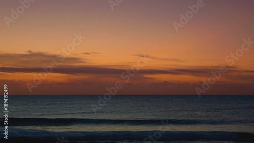 Ocean Sunrise with Orange and Pink Sky Over Calm Water