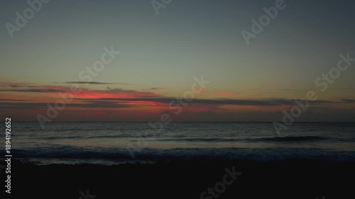Calm Ocean Sunrise with Colorful Sky and Gentle Waves at Shore