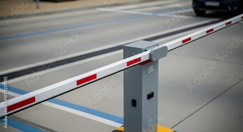 Automatic barrier gate with red and white stripes in a parking lot automatic gate security access control
