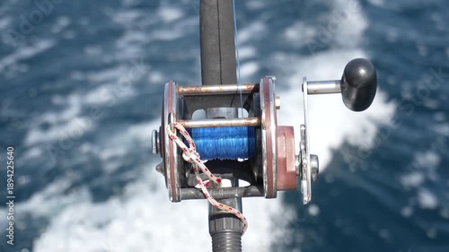 Trolling rod reel, fish caught on a hook, trolling fishing in the sea