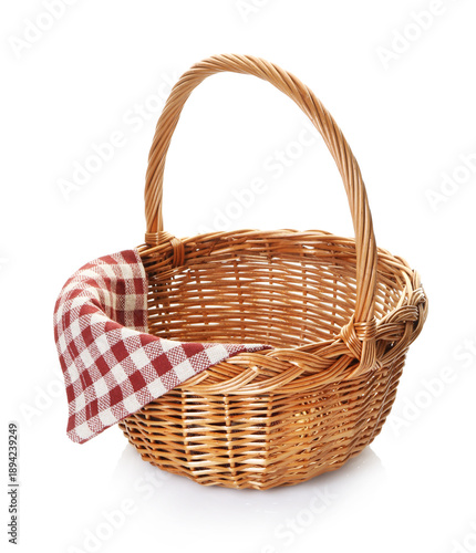Wicker basket with napkin isolated on white