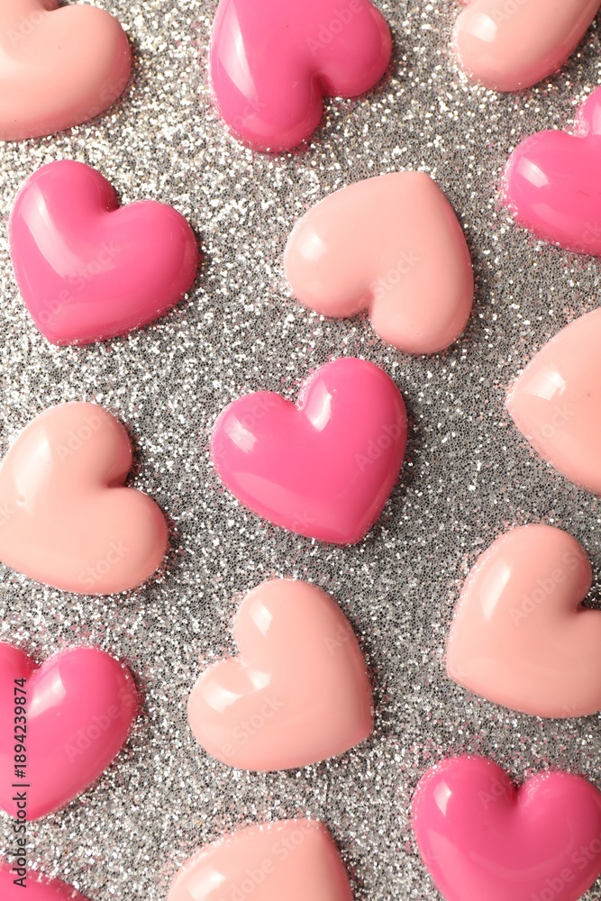 Obraz premium Love. Pink decorative hearts on shiny gray background, flat lay