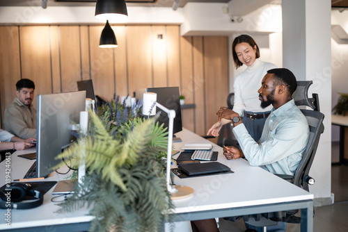 Photos Diverse team members collaborating in a modern office workplace