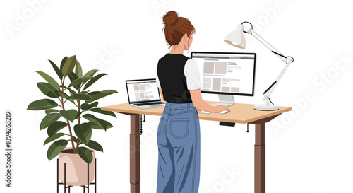 Woman working on computer at desk with plant and lamp in a modern office environment from behind viewpoint